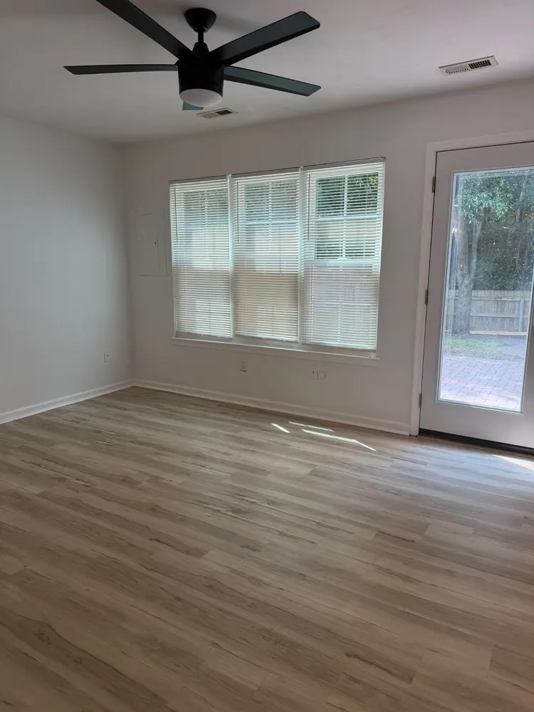 Empty family room with clean floors, ready for move-in