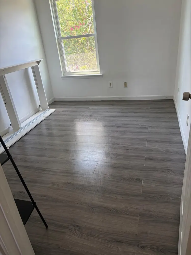 Small work room with clean gray floors and a white desk